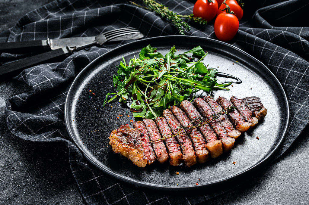 Sliced Strip Steak with Arugula and Parsley